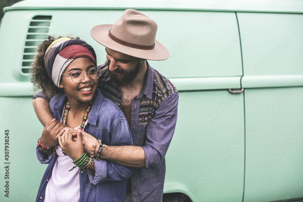 Hippie stylish man and woman embracing together Hippie stylish man and woman embracing together