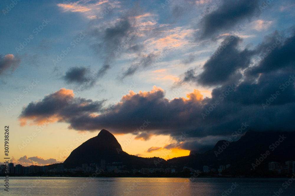 Sunset at Lagoa Rodrigo de Freitas with the Dois Irmãos Hill, postcard of the city of Rio de Janeiro. Brazil Sunset at Lagoa Rodrigo de Freitas with the Dois Irmãos Hill, postcard of the city of Rio de Janeiro. Brazil