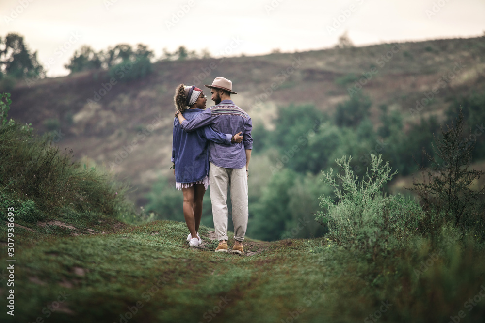 Stylish man and woman staying on nature hill Stylish man and woman staying on nature hill