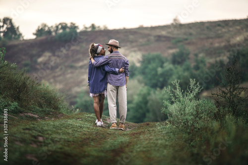 Stylish man and woman staying on nature hill © Yakobchuk Olena