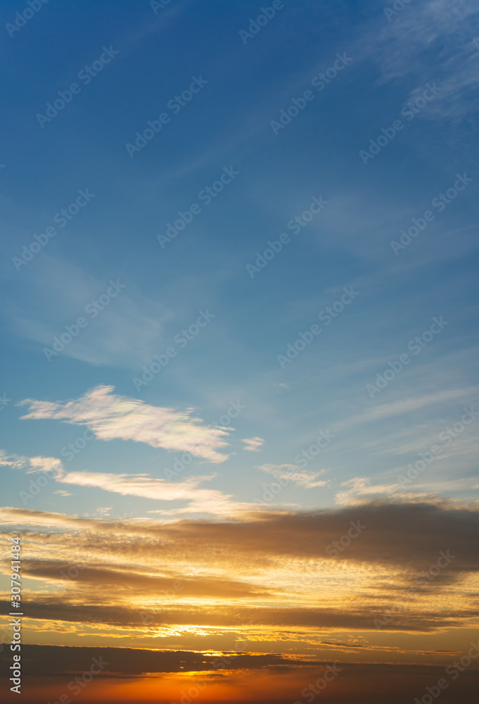 Fototapeta premium Fantastic clouds at sunrise, vertical panorama