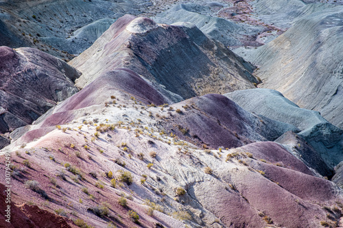 Amazing blend of purple, magenta and blue colors dancing across the hills of the Little Painted Desert in Navajo County, Winslow, AZ