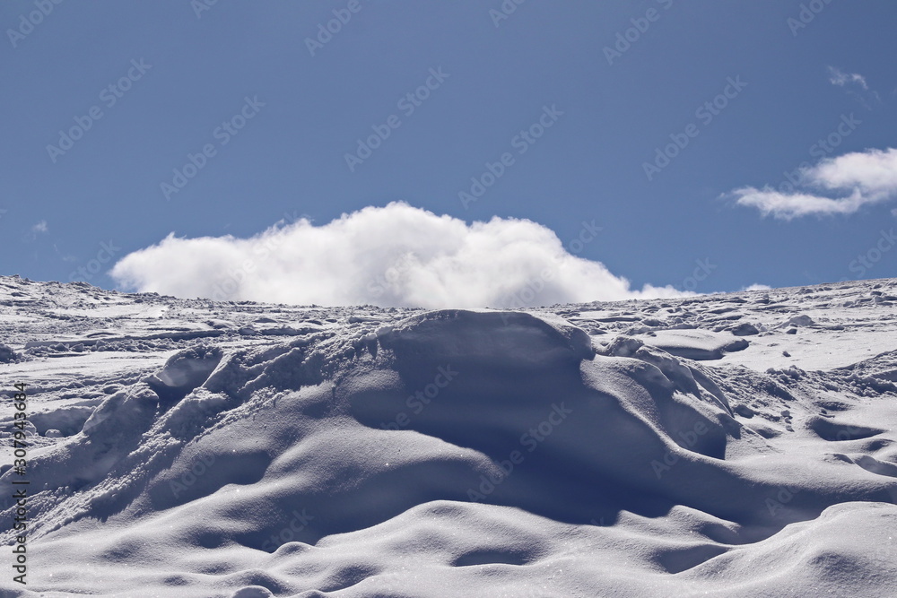 Fototapeta premium snowy mountain side and deep blue sky