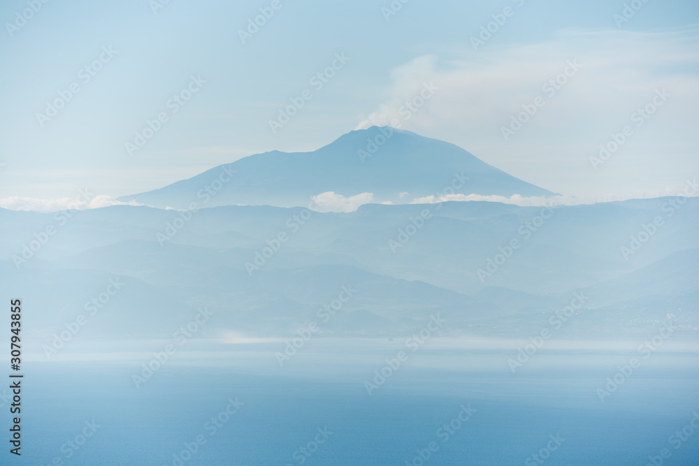 the etna active volcano blue silhouette trough atmospheric perspective