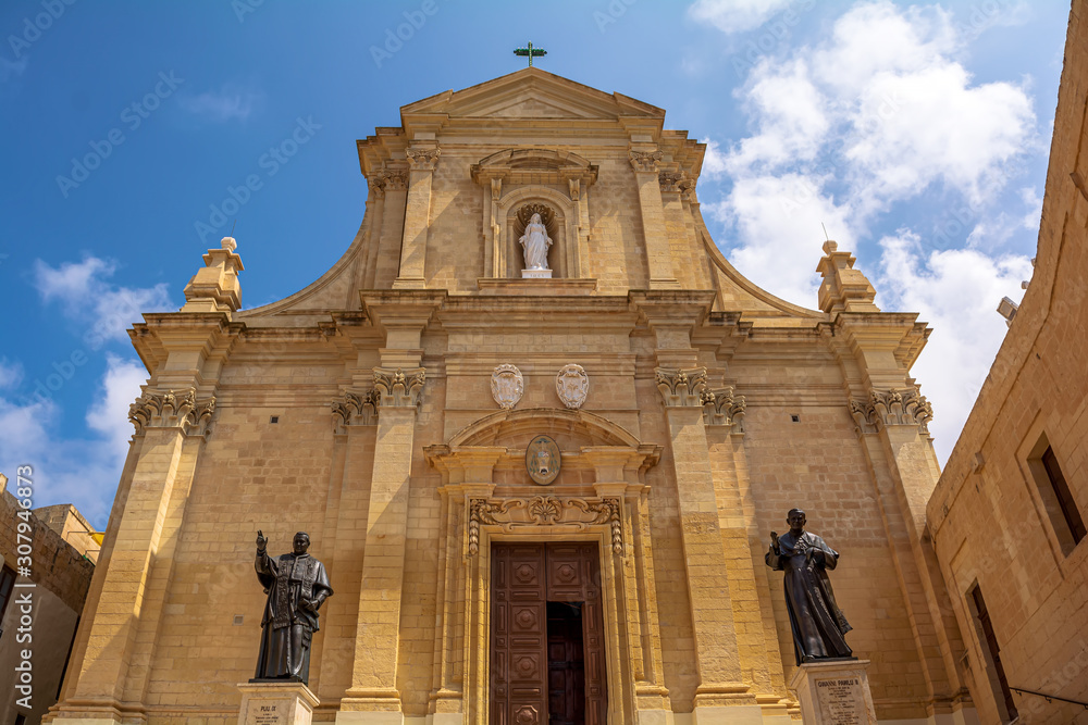 Facade of the Cathedral of the Assumption in the Cittadella of Victoria in Gozo, Malta. Cathedral is a fine baroque structure in the form of a Latin cross. It is built entirely from local limestone.