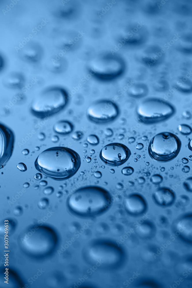 Macro photo of drops with sparkles. Color of the year 2020 - Classic Blue. Macro photo of drops with sparkles. Color of the year 2020 - Classic Blue.