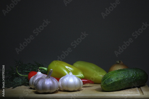Фотография vegetables hot peppers, cucumbers, onions, garlic, dill on a wooden Board, selec