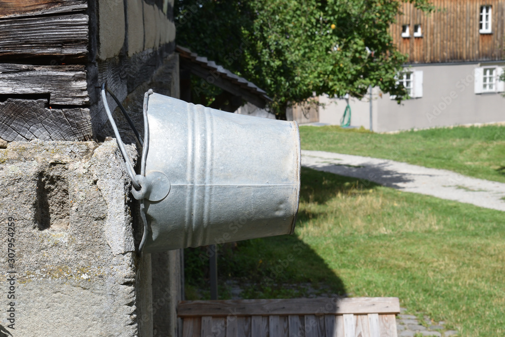 Old Steel Bucket Hanging on Stone Wall 6970-042 Old Steel Bucket Hanging on Stone Wall 6970-042