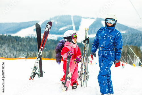 Winter, ski - Little girl with mother in ski resort