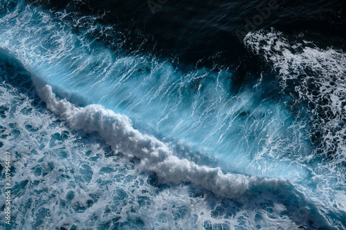 Fototapeta Naklejka Na Ścianę i Meble -  Aerial view to waves in ocean Splashing Waves. Blue turbid wavy sea water. Bali, Indonesia.