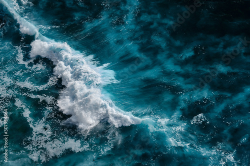 Fototapeta Naklejka Na Ścianę i Meble -  Aerial view to waves in ocean Splashing Waves. Blue clean wavy sea water. Bali, Indonesia.