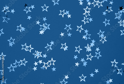 Glitter stars Christmas background on trendy classic blue toned background  flatlay  selective focus