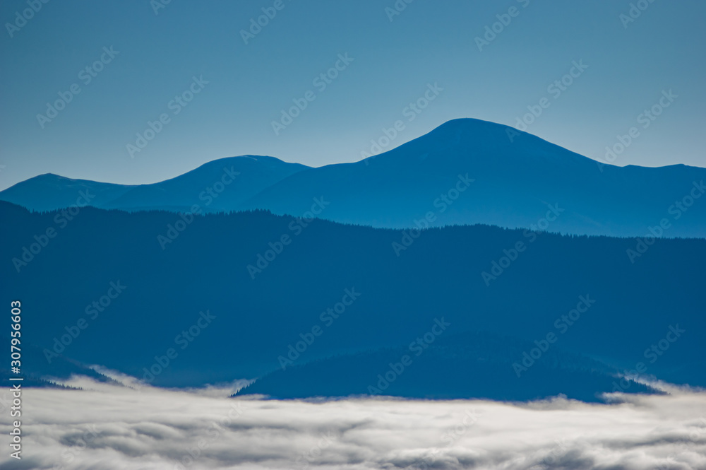 Carpathian mountains in the waves of fog
