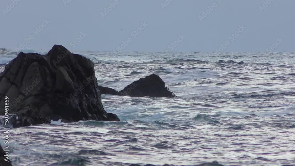 Rugged volcanic rocky shore in San Cristobal (or Chatham Island), the easternmost island in the Galapagos Archipelago, 2019 Rugged volcanic rocky shore in San Cristobal (or Chatham Island), the easternmost island in the Galapagos Archipelago, 2019