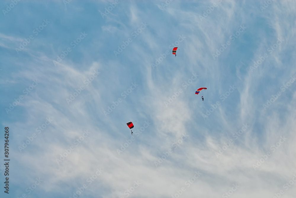 Some people dropping in from above on parachutes. Some people dropping in from above on parachutes.