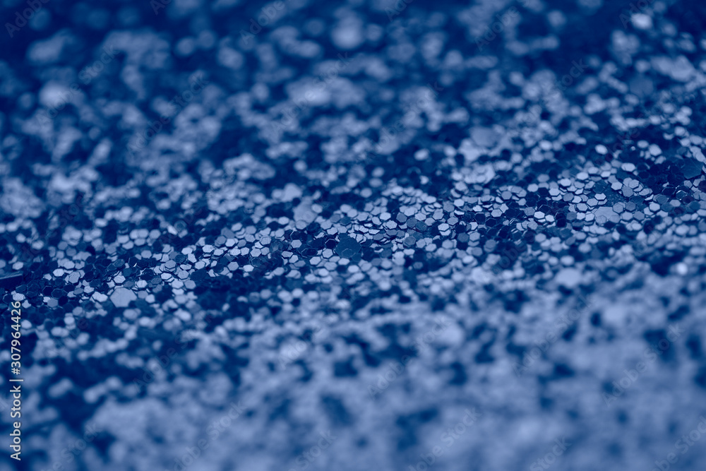 Sparkle background in blue color. Magical macro shot of glitter.