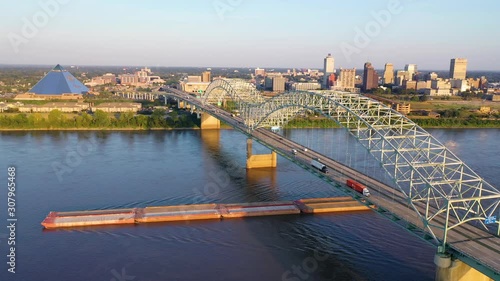 Good aerial over the Hernando de Soto Bridge Mississippi River and barge revealing Memphis, Tennessee. photo