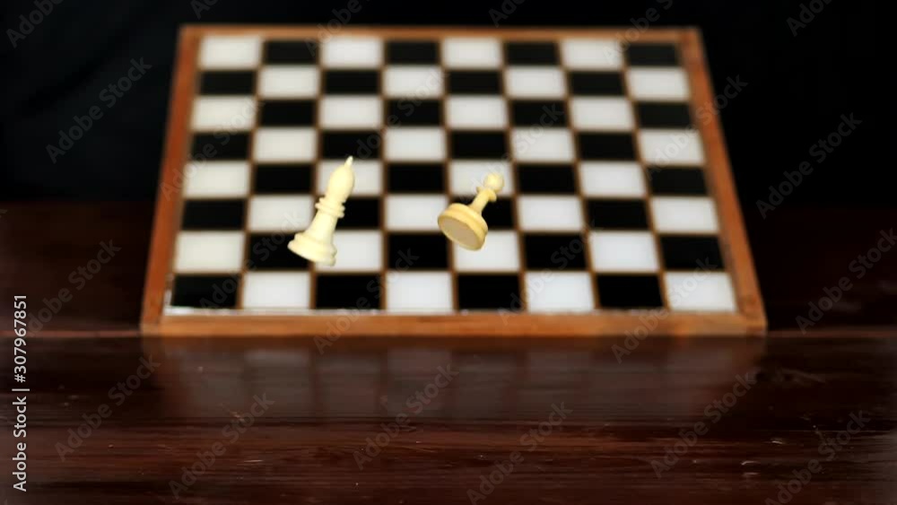 Yuriy Chess pieces. White pieces fall from above. Slow motion. Chess board from hard strategy logic game. Yuriy Chess pieces. White pieces fall from above. Slow motion. Chess board from hard strategy logic game.