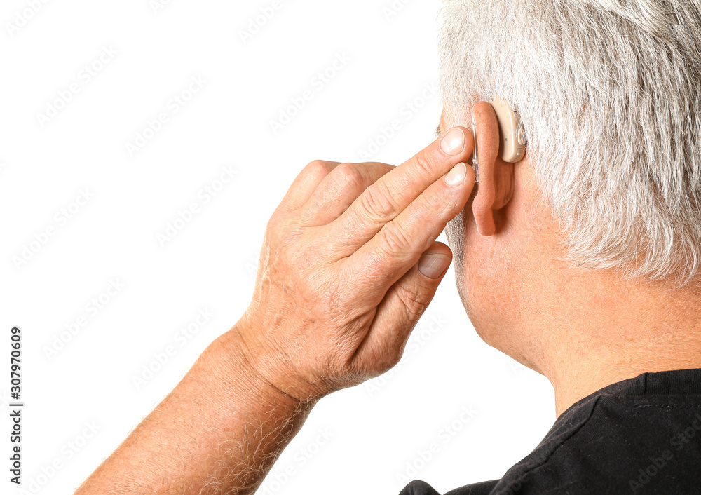 Mature man with hearing aid on white background Mature man with hearing aid on white background