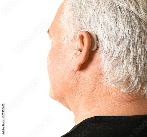 Mature man with hearing aid...