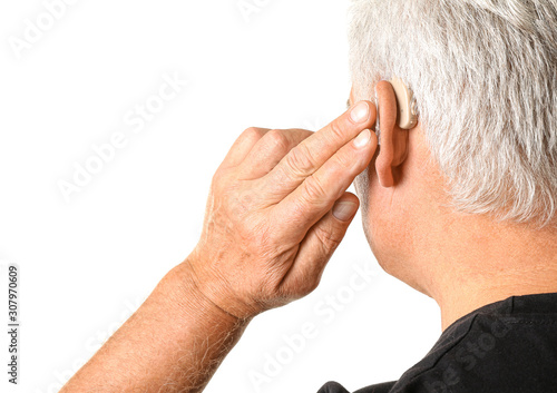 Mature man with hearing aid...