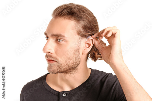 Young man with hearing aid ...