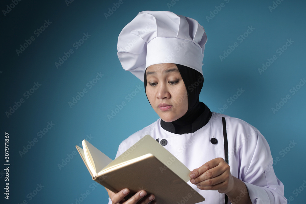 Woman Chef Reading Book of Recipes Woman Chef Reading Book of Recipes