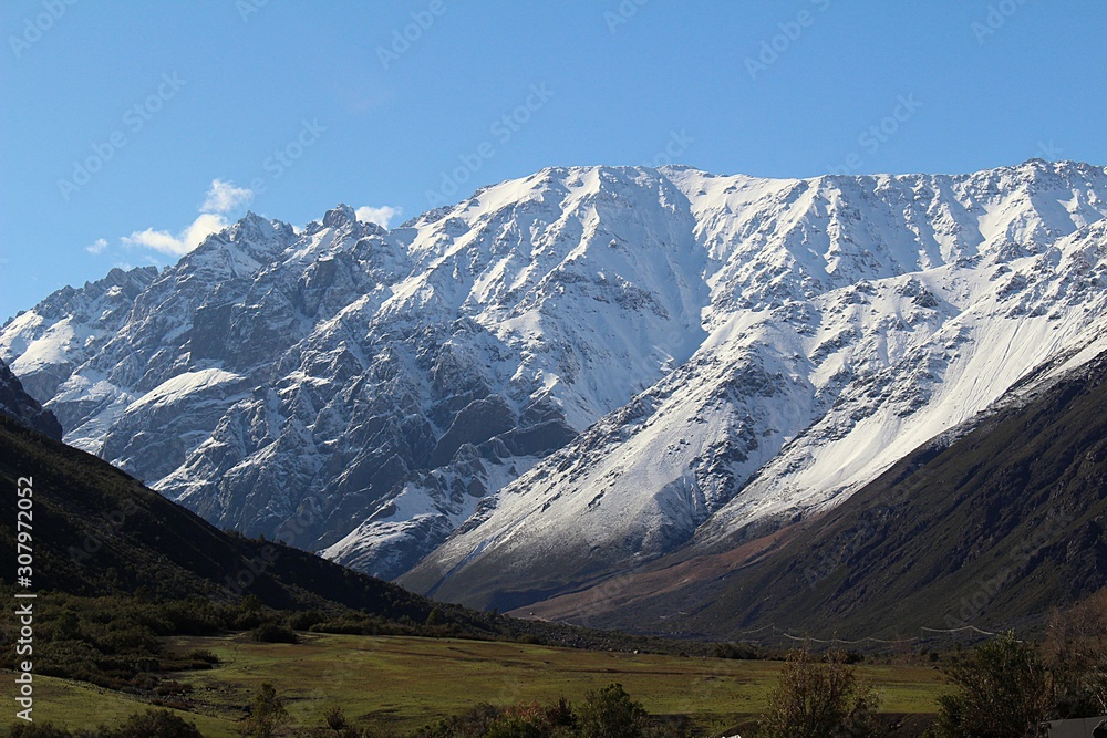 Beautiful mountain landscape. High peaks of snowy mountains and a valley in a gorgeous place among the mountains called Cajón del Maipo in the central Andes of Chile, South America.