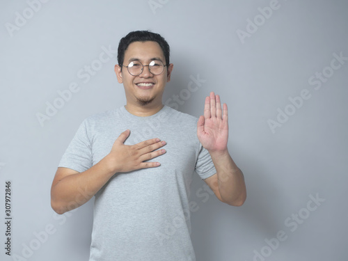 Photography Man Making Pledge Gesture, Hand on Chest, Making Promise