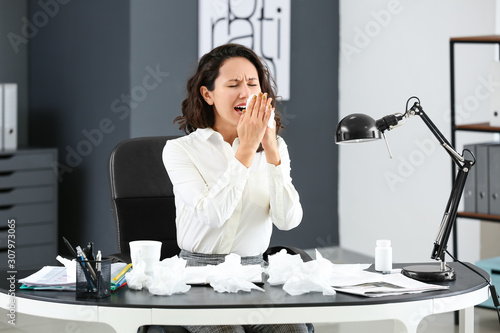 Woman ill with flu working ...