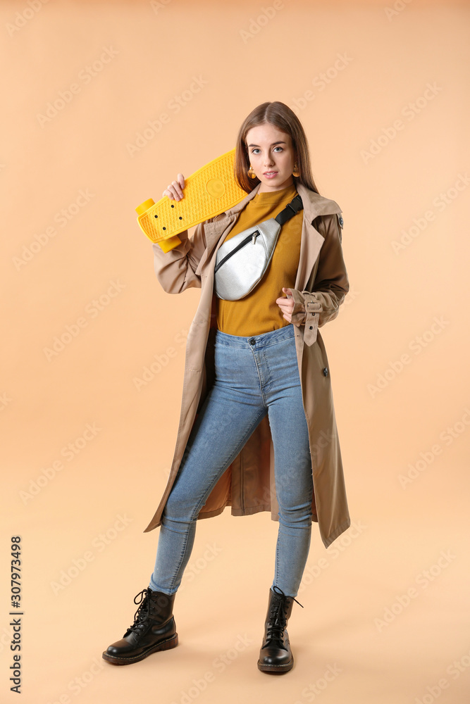 Stylish hipster girl with skateboard on color background Stylish hipster girl with skateboard on color background