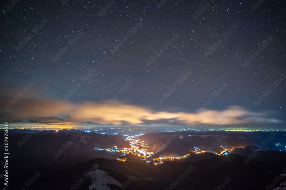 Night city in the fog in the mountains in autumn Night city in the fog in the mountains in autumn