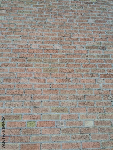 A multicolored brick wall in the sun