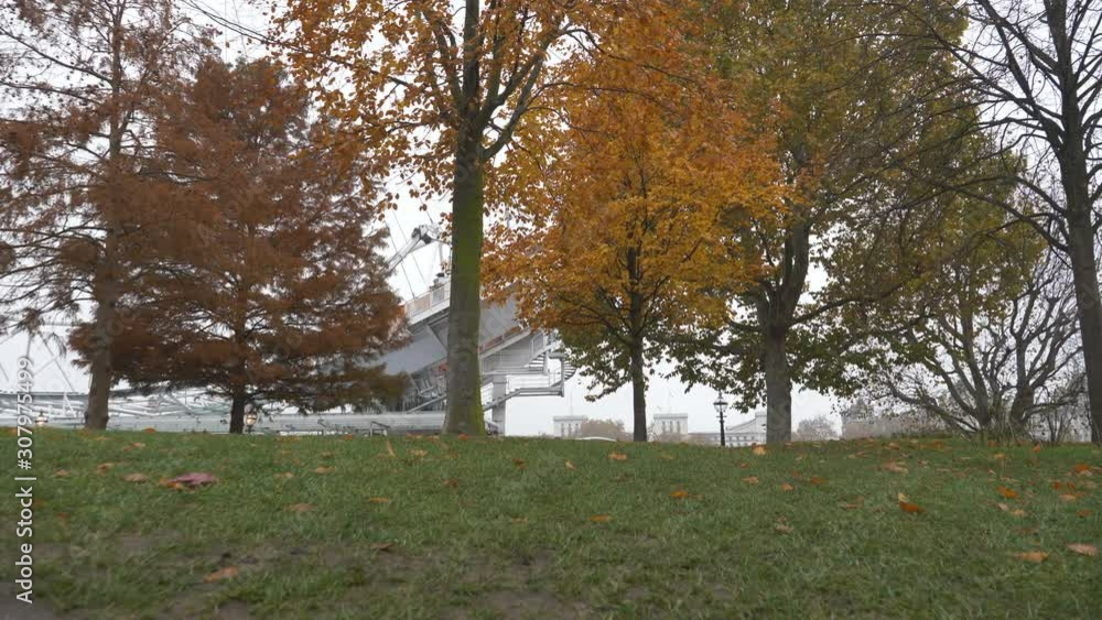 A panning shot of a row of multicolored trees in autumn. A panning shot of a row of multicolored trees in autumn.