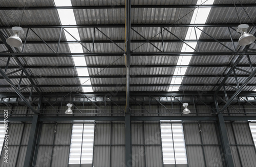 Warehouse metal roofing, Large steel roof structure, bottom view with skylight translucent roof. © Pakawat