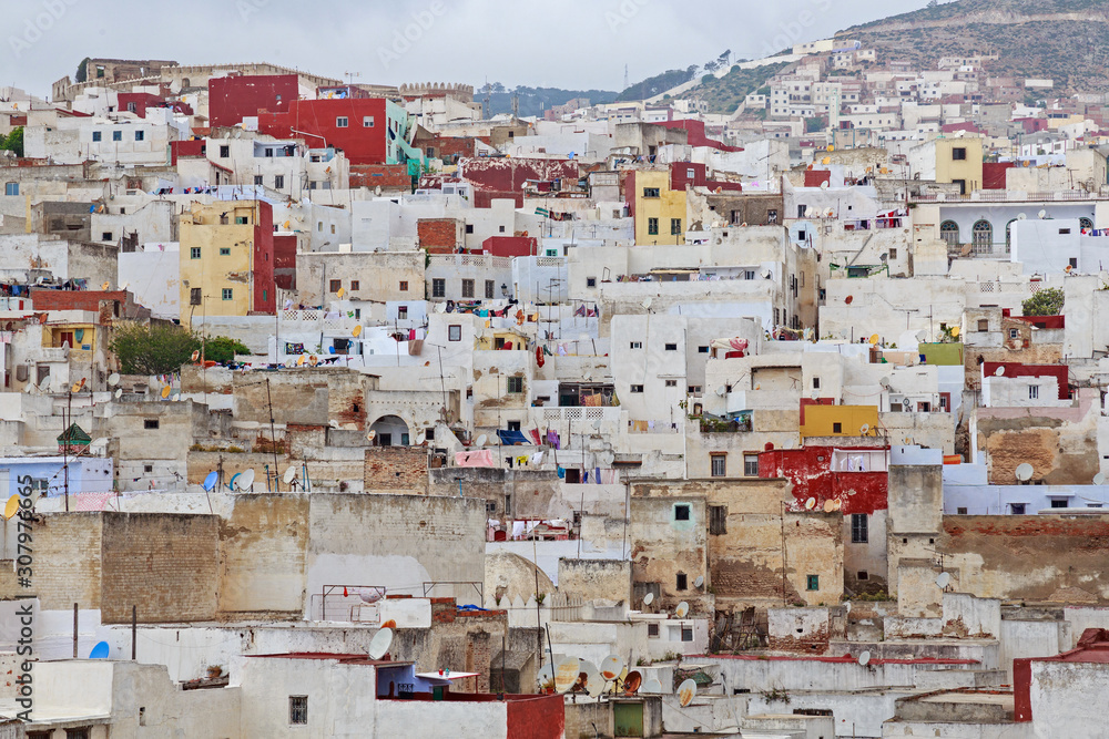 View of the colorful old buildings of Tetouan Medina quarter in Northern Morocco. A medina is typically walled, with many narrow and maze-like streets and often contain historical houses and places.
