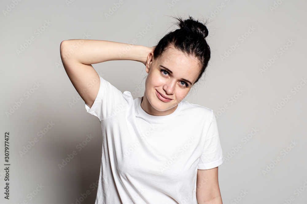 Nice, shy young woman smiling and looking cute enamored eyes into the camera. Nice, shy young woman smiling and looking cute enamored eyes into the camera.