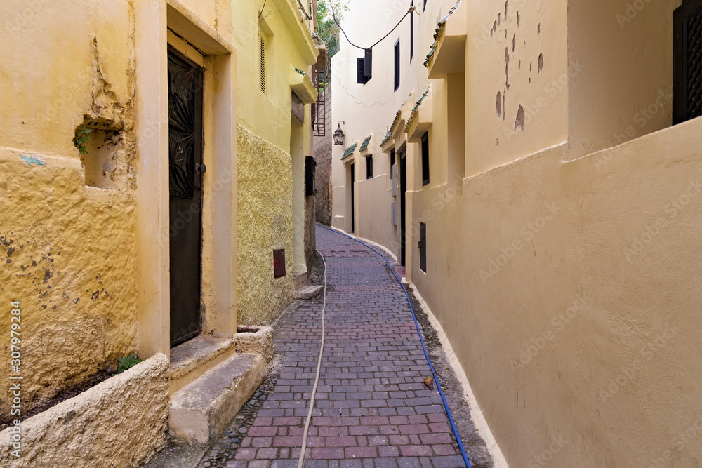 View of the one of the old streets in the Tangier Medina quarter in Northern Morocco. A medina is typically walled, with many narrow and maze-like streets.