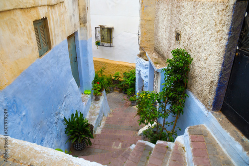 View of the one of the old colorful streets in the Tangier Medina quarter in Northern Morocco. A medina is typically walled, with many narrow and maze-like streets.