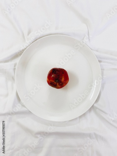 Top shot of pomegranate placed on a plate.