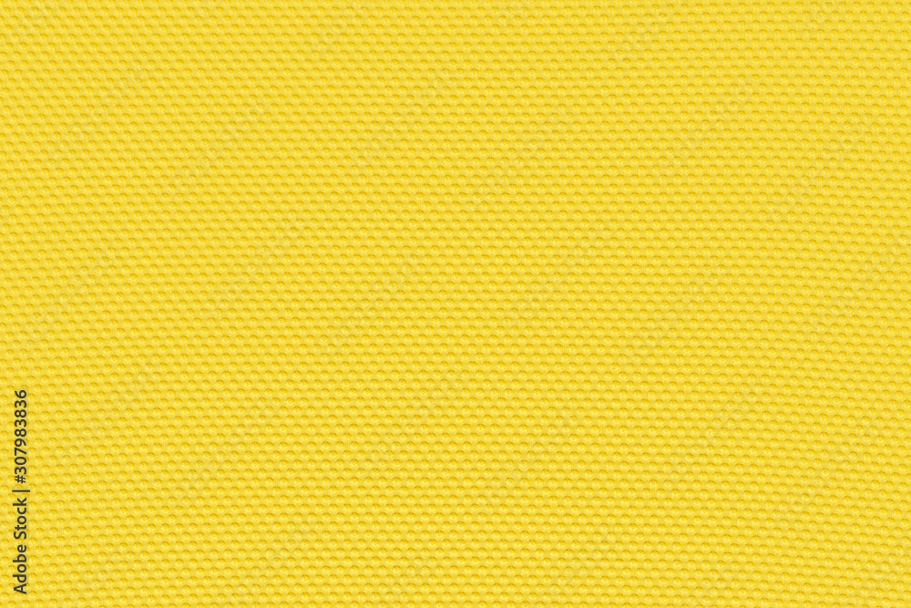 Golden yellow background from a textile material with pattern, closeup. Structure of banana yellow fabric with punching texture. Perforated cloth backdrop. Golden yellow background from a textile material with pattern, closeup. Structure of banana yellow fabric with punching texture. Perforated cloth backdrop.