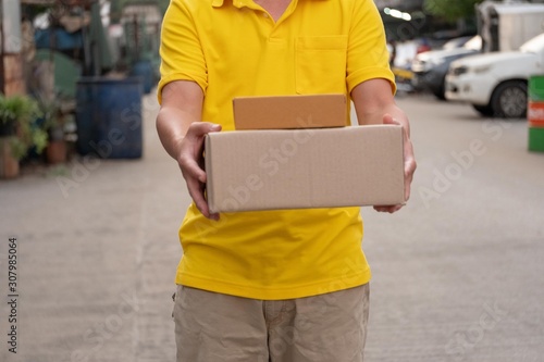Yellow delivery man carry parcels.