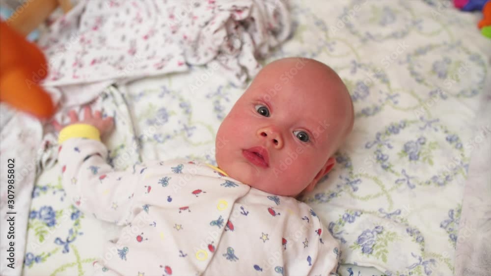 Top portrait of adorable newborn baby boy in pajamas in his bed Top portrait of adorable newborn baby boy in pajamas in his bed