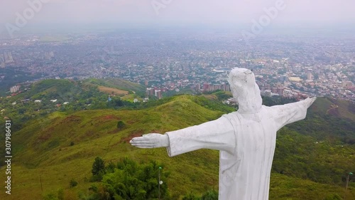Aerial shot around the Cristo Rey statue in Cali, Colombia. photo