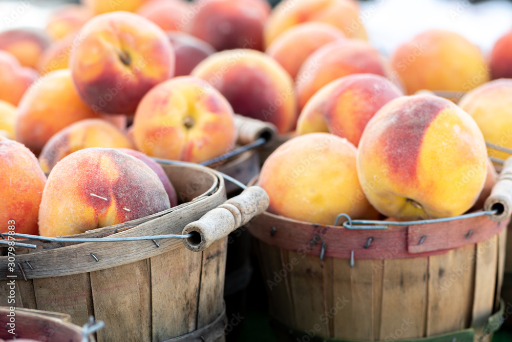 Displays of fresh peaches for sale at a local farmers market Displays of fresh peaches for sale at a local farmers market