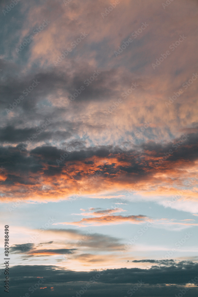 Uniform background for the screensaver. Pink and blue gentle clouds at sunset.