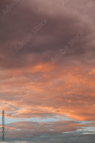Uniform background for the screensaver. Pink and blue gentle clouds at sunset. © pavelvozmischev