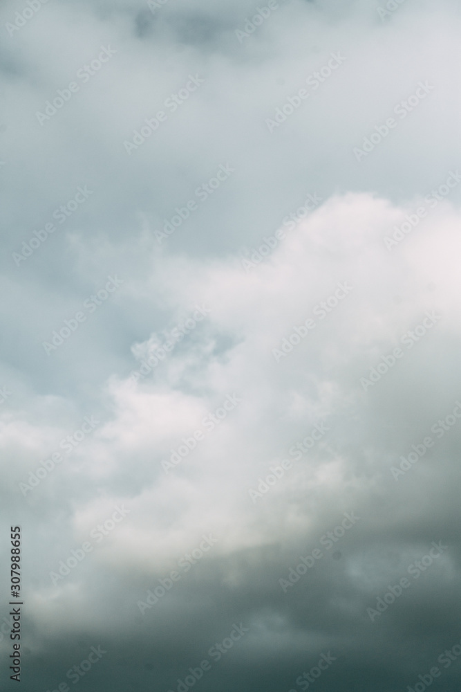 Screensaver and background for design. Gloomy and dark clouds with rain.