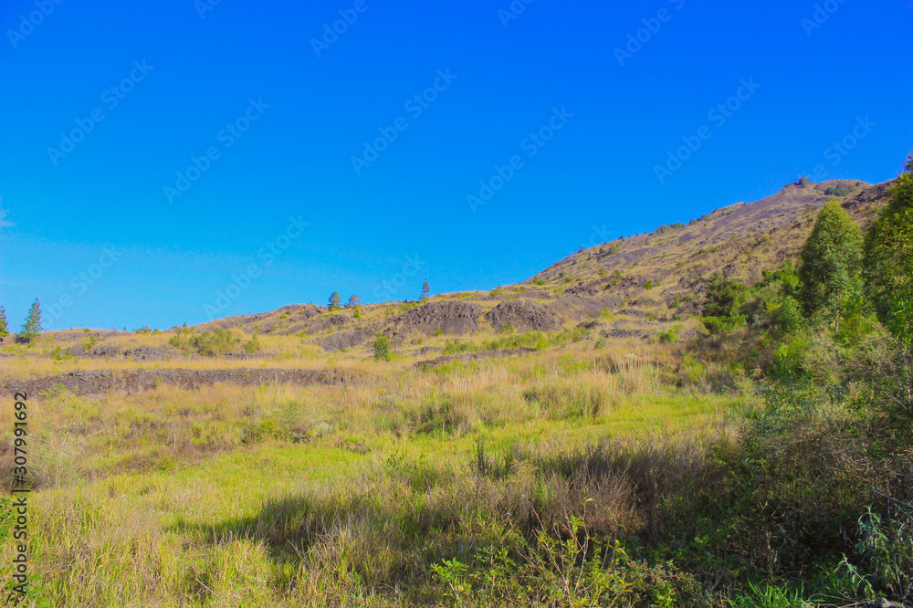 green landscape hill with beautiful blue sky in Batur Mountain, Kintamani, Bali, Indonesia. green landscape hill with beautiful blue sky in Batur Mountain, Kintamani, Bali, Indonesia.