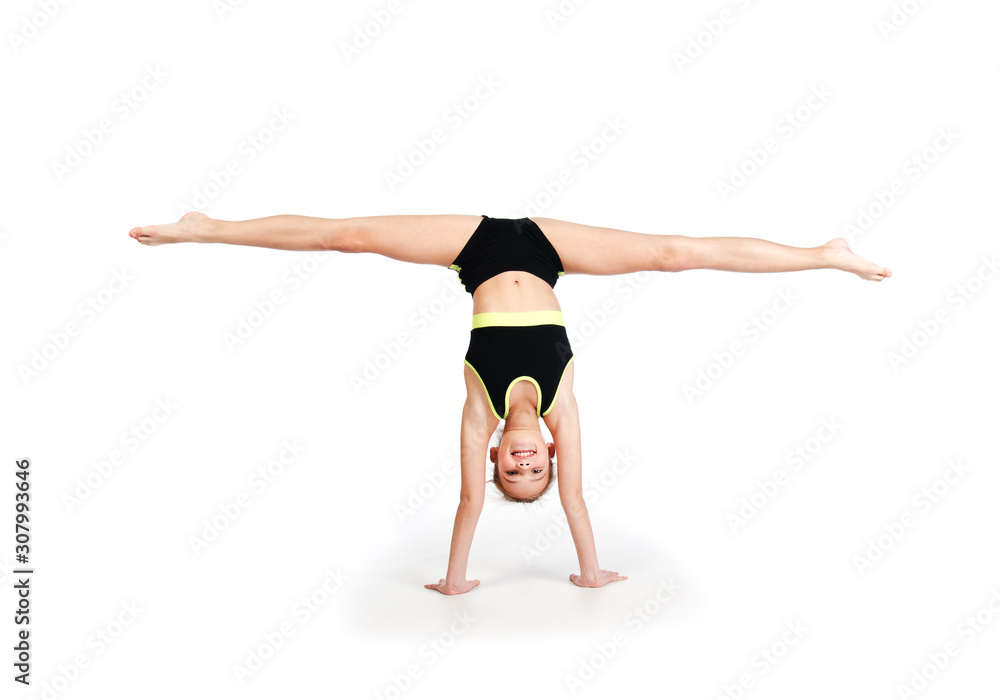 Flexible cute little girl child gymnast doing acrobatic exercise isolated on a white background Flexible cute little girl child gymnast doing acrobatic exercise isolated on a white background